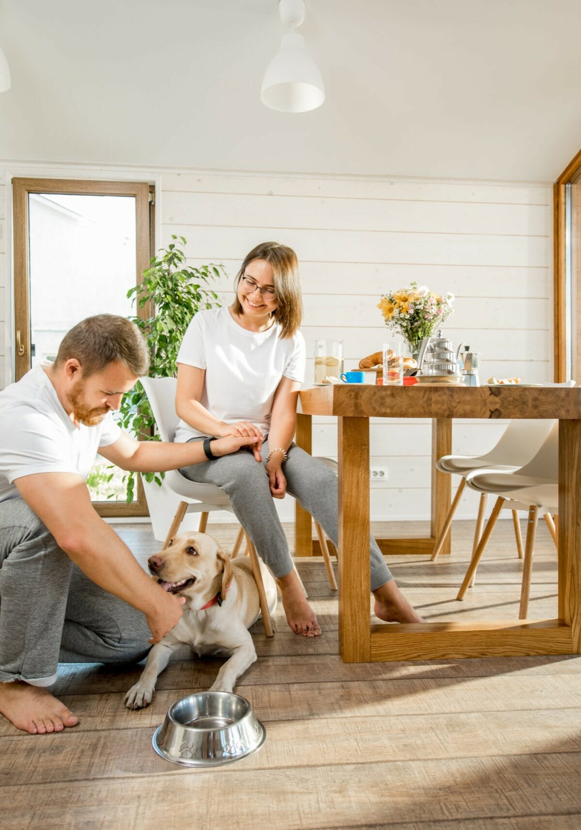 Young couple with dog at home | Mallary Carpet & Flooring